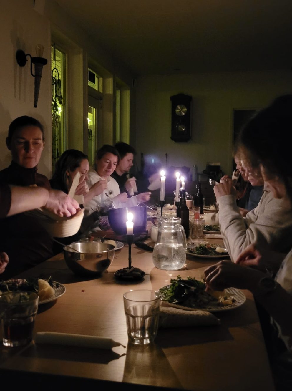 Group sharing a candlelit meal